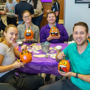 Students painting pumpkins at Fall Fest.